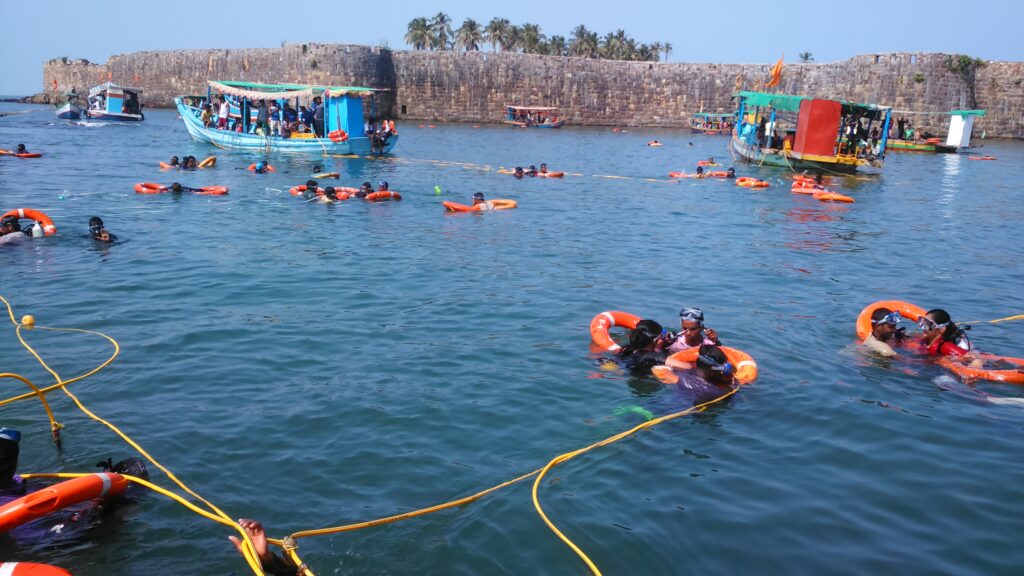 Divers jumping into the waters at Tarkarli